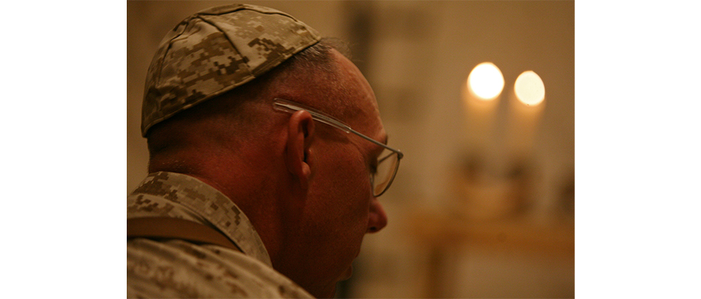 Jewish New Year - a Time for Reflection of Inner Self: Col. Kevin Vest, the commanding officer of Marine Aircraft Group 40, Marine Expeditionary Brigade-Afghanistan, follows along in prayer at a Rosh Hashanah service, Sept. 18, 2009, at Camp Leatherneck in Helmand province, Afghanistan. The process of reflection and repentance takes place over a 40-day period that begins about four weeks before Rosh Hashanah, at the start of the month known as Elul on the lunar Jewish calendar. (Photo by Cpl. Aaron Rooks)